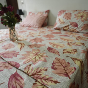 Rustic autumn leaf print duvet cover set with rust, pink, and gold foliage on a textured grey background
