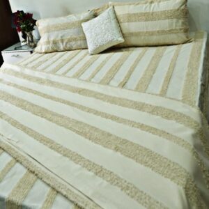 Cream tufted duvet set with chenille stripes, four pillow covers, and decorative cushion on a bed