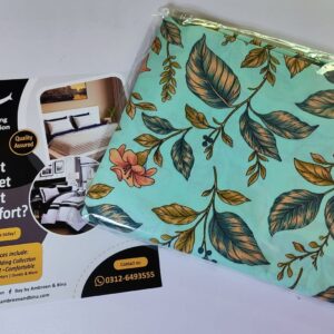 Mint green bed sheet set with peach floral and green leaf botanical print folded in packaging